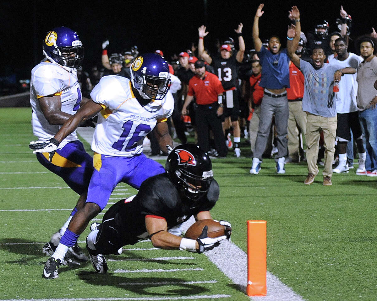 Incarnate Word running back Trent Rios dives into the end zone for a third-quarter touchdown ahead of Devonte Mooris (16) of Texas College during football action at Benson Stadium on Saturday, Sept. 1, 2012.