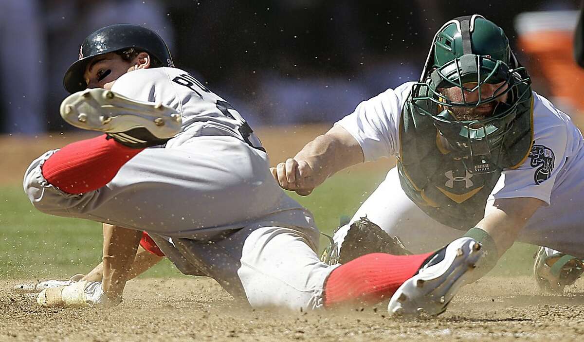 Boston Red Sox's Scott Podsednik, left, is tagged out at home plate by Oakland Athletics catcher Derek Norris in the sixth inning of a baseball game, Sunday, Sept. 2, 2012, in Oakland, Calif. Scott Podsednik was attempting to score on a single by Cody Ross. (AP Photo/Ben Margot)