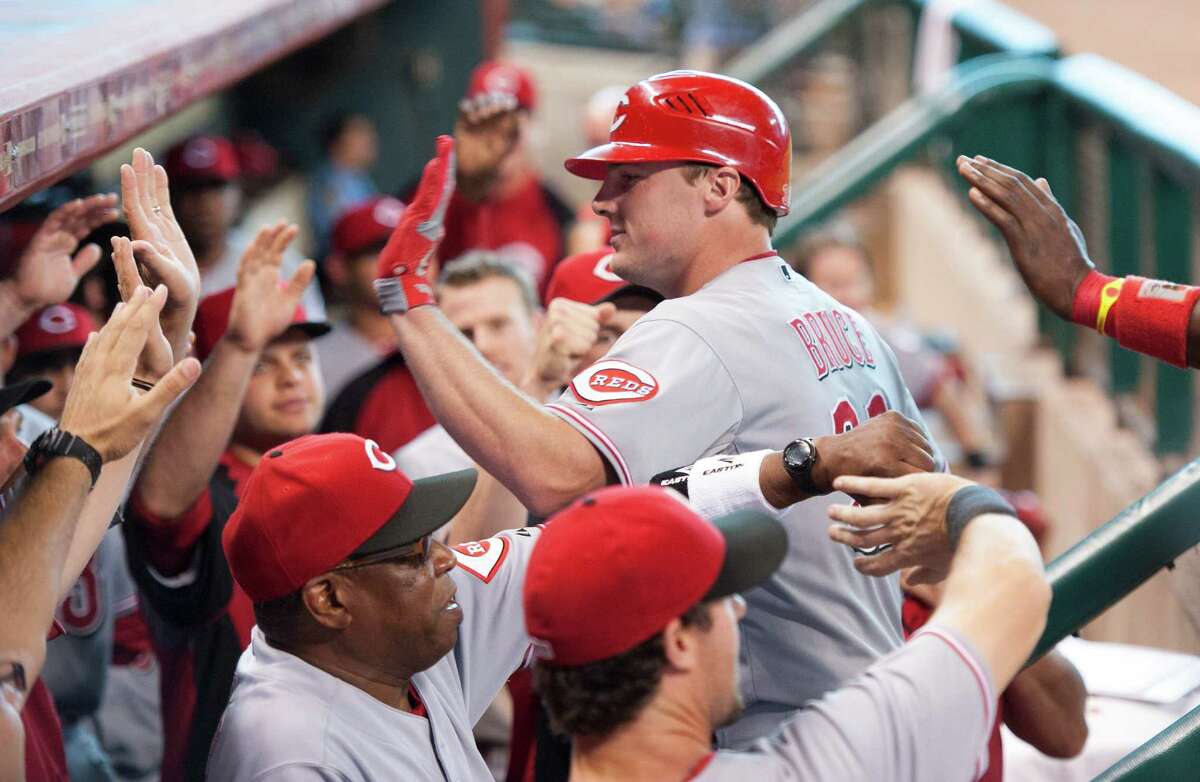 Cincinnati Reds' Jay Bruce, center, is congratulated by teammates after hitting a three-run home run during the eighth inning of a baseball game against the Houston Astros, Sunday, Sept. 2, 2012, in Houston. (AP Photo/Dave Einsel)