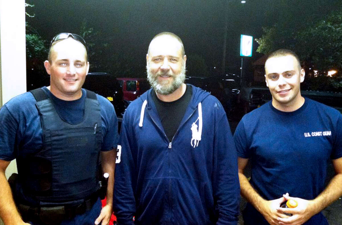 A photo provided by the U.S. Coast Guard shows Russell Crowe, center, with Coast Guard petty officers Robert Swieciki, left, and Thomas Watson Sunday Sept. 2, 2012. Crowe and a friend became disoriented while kayaking in Long Island Sound Sunday and called the Coast Guard for assistance. (AP Photo/U.S. Coast Guard)