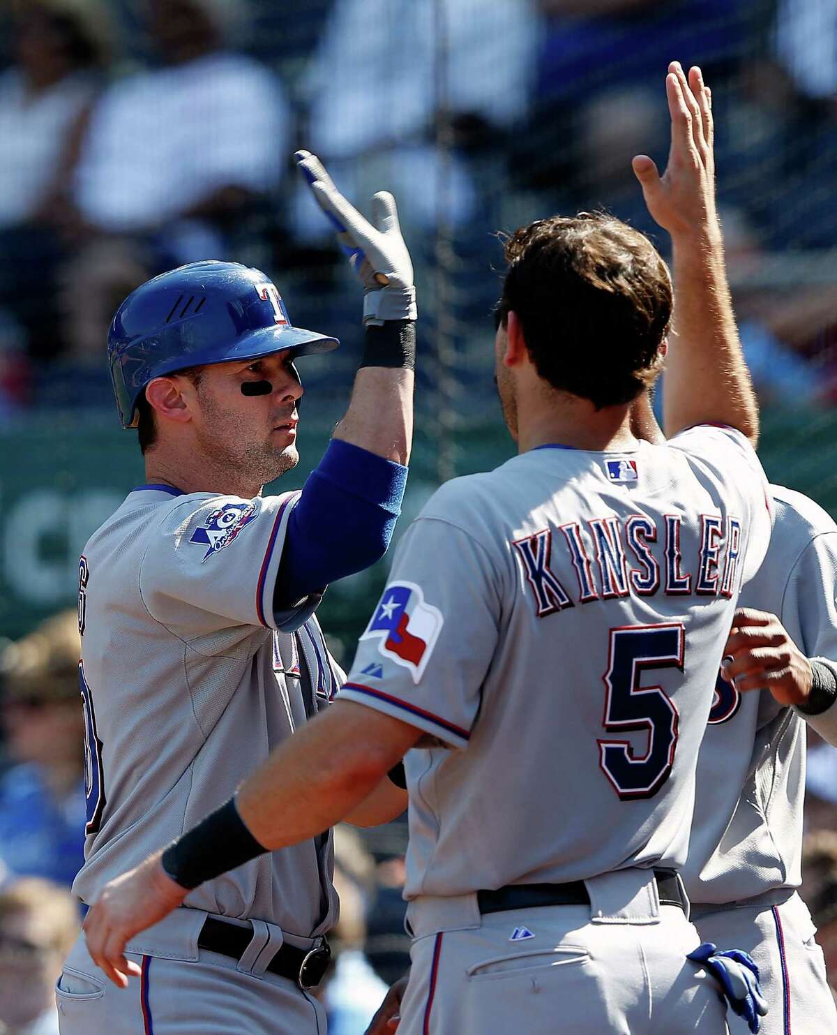 Michael Young (left) is congratulated by Rangers teammate Ian Kinsler after hitting a home run in the eighth.