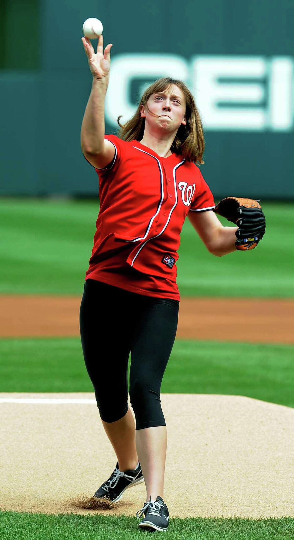 Gold medal swimmer Katie Ledecky, 15, throws out the first pitch before the Nationals-Cubs game in Washington.