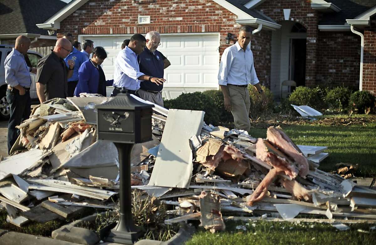 President Barack Obama walks past debris on the sidewalks as he tours the Bridgewood neighborhood in LaPlace, La., in the Saint John the Baptist Parish, with local officials to survey the ongoing response and recovery efforts to Hurricane Isaac, Monday, Sept. 3, 2012. (AP Photo/Pablo Martinez Monsivais)