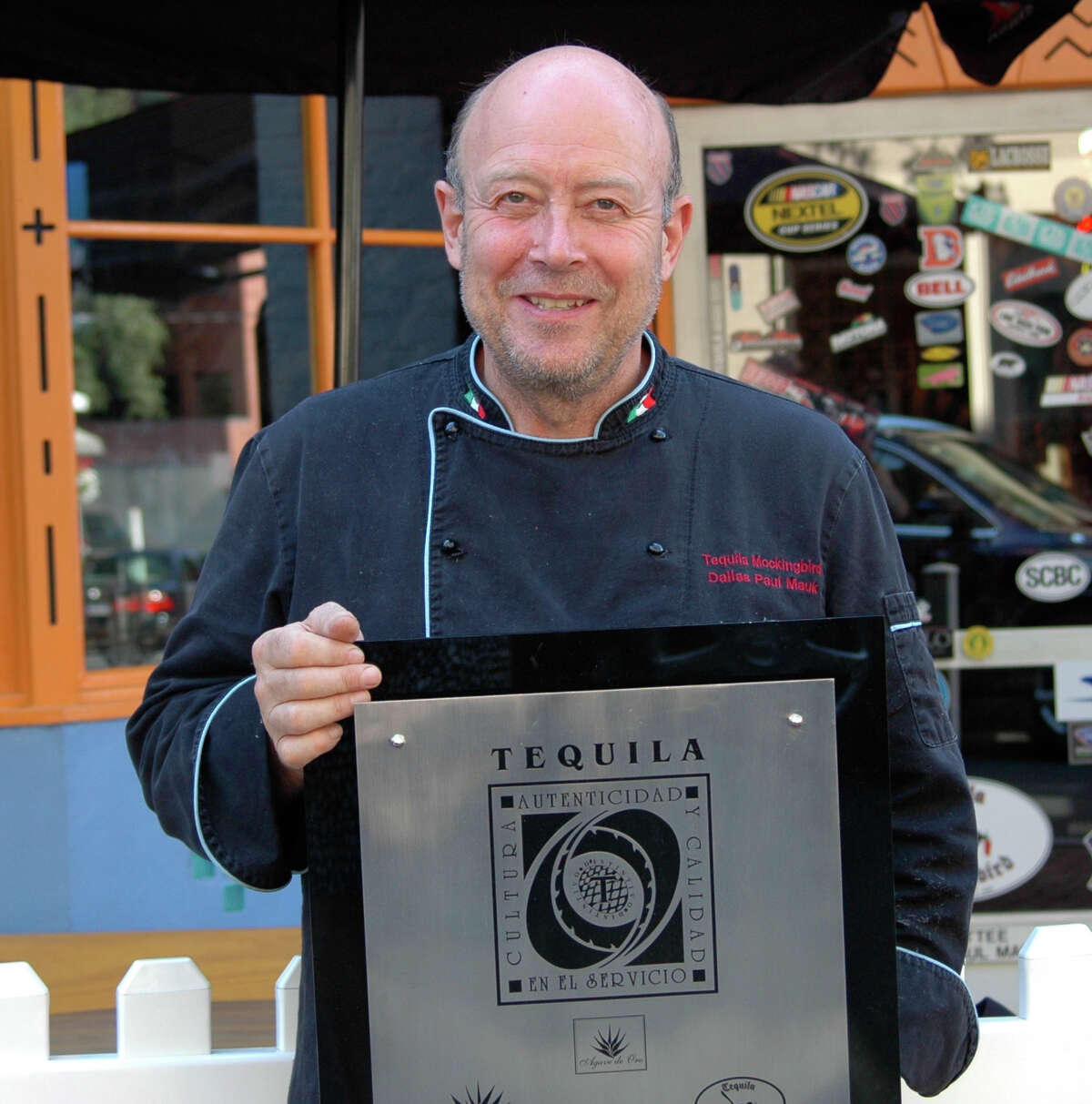 Dallas "Paul" Mauk, chef and owner of Tequila Mockingbird, holds the CRT Award T certification plaque his establishment recently received.