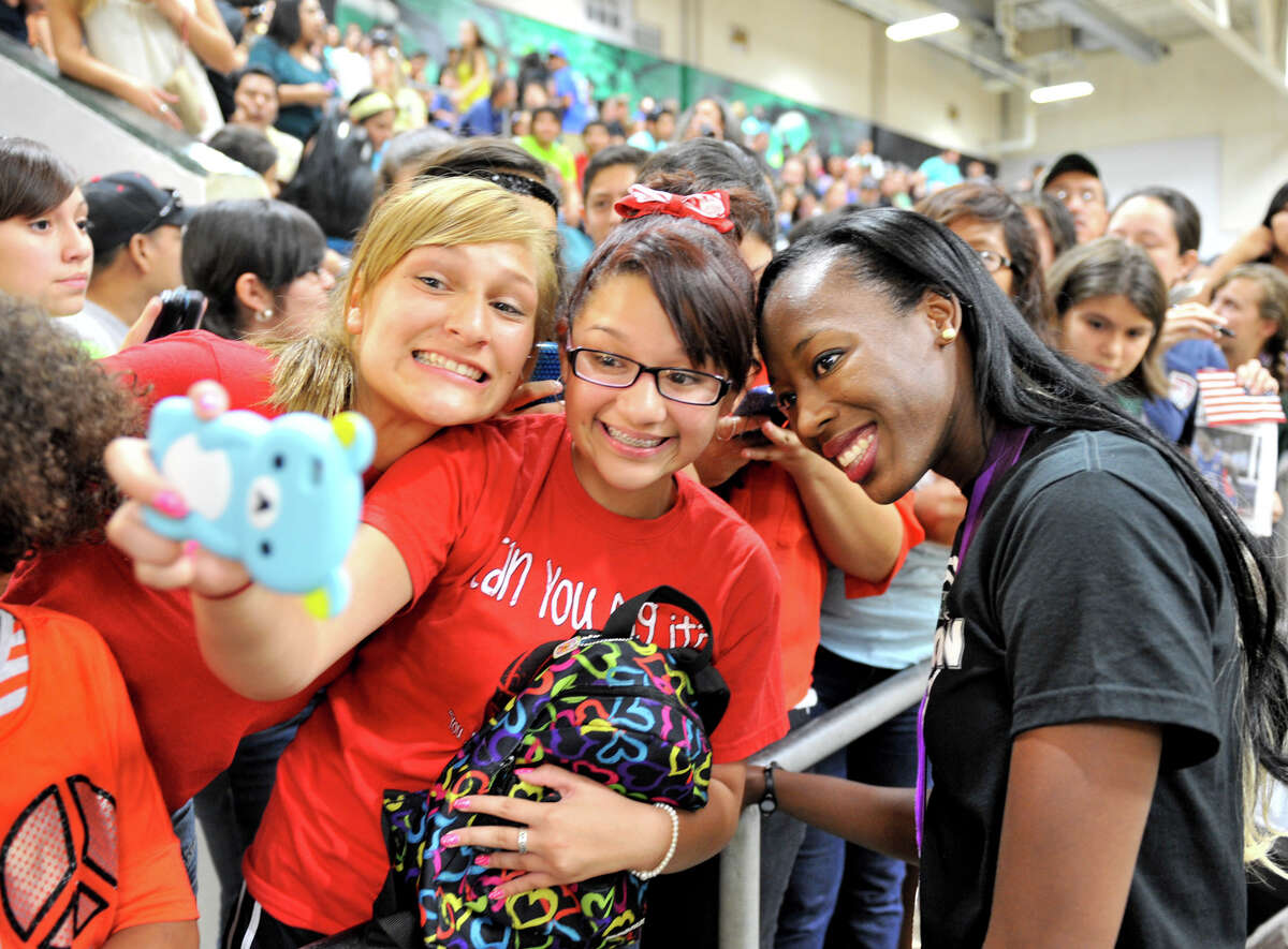 Olympic volleyball silver medalist and Southwest graduate Destinee Hooker (right) takes pictures with Jessica Morales (left) and Gabriella Valdez after the school retired her volleyball jersey during a ceremony Tuesday evening, Sept. 4, 2012.