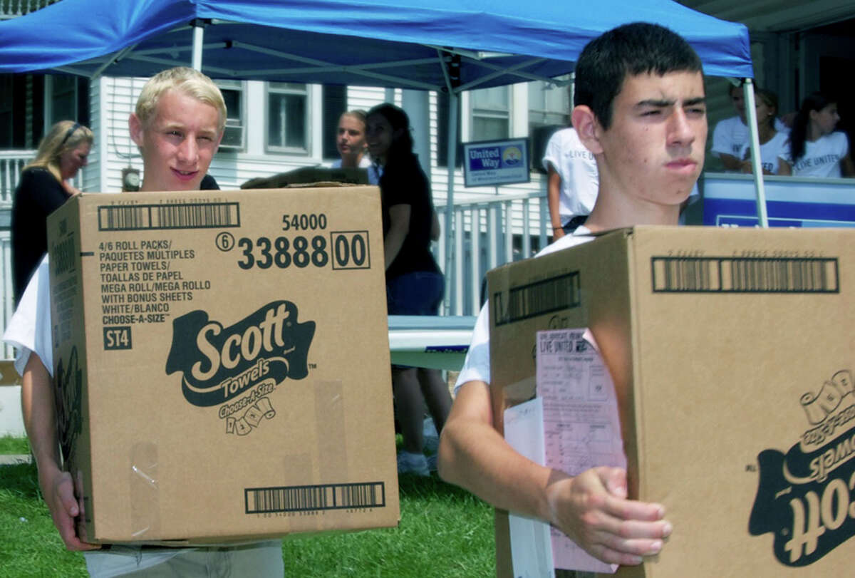 John Hansell, 17, of New Milford and Chris Mello, 15, of Bethel lend a hand during the United Way's Back to School event held Aug. 17, 2012 in New Milford.