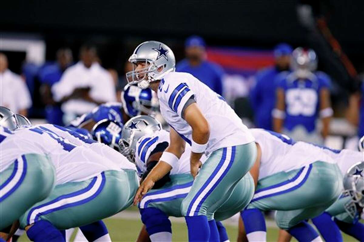 Dallas Cowboys' Tony Romo looks up during the first half of an NFL football game against the New York Giants Wednesday, Sept. 5, 2012, in East Rutherford, N.J. (AP Photo/Julio Cortez)