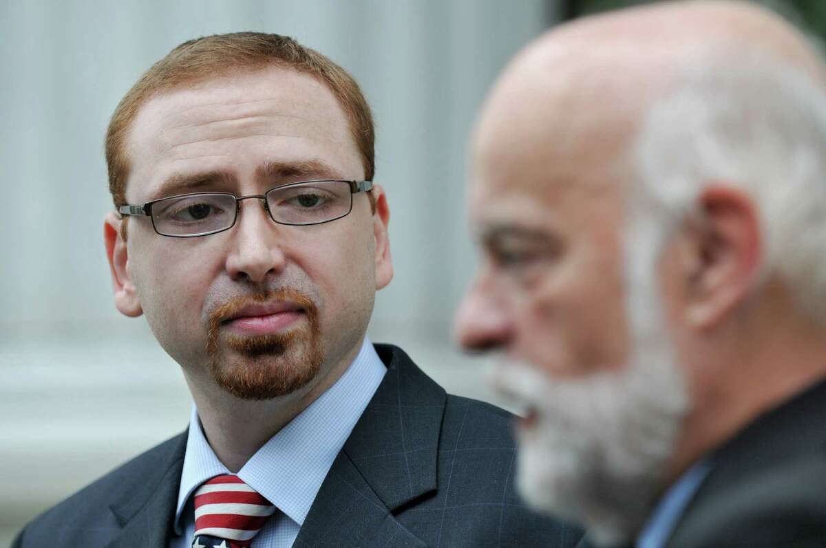 Stephen Dick, Jr., owner of Night Moves, left, listens as attorney W. Andrew McCullough, right, is interviewd outside of the New York State Court of Appeals after arguments about taxes the state tax appeals tribunal said they owe, on Wednesday afternoon Sept. 5, 2012 in Albany, NY. (Philip Kamrass / Times Union)