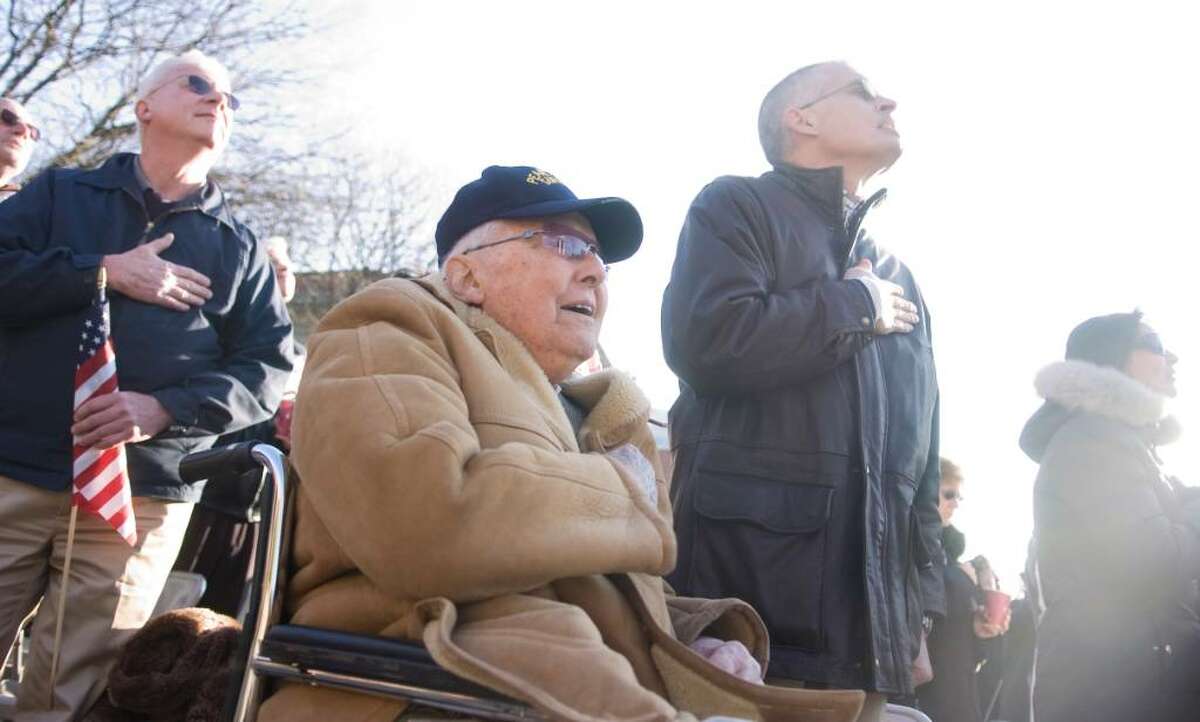 Pearl Harbor survivor James Benham, 92, center, sings the National Anthem during a Pearl Harbor remembrance ceremony at Veteran's Park in Stamford, Conn. on Sunday, Dec. 6, 2009. After Elwood Lichack died earlier this year, Benham became the last known Pearl Harbor survivor in lower Fairfield County.