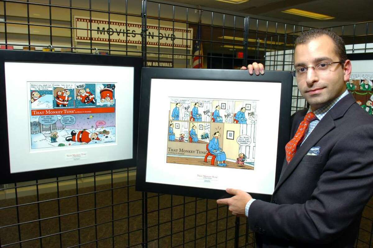 Michael Kandalaft, creator of "That Monkey Tune" comic, poses with some of his art work, which is on display at the Stratford Public Library, in Stratford, Conn. Nov. 30th, 2009.