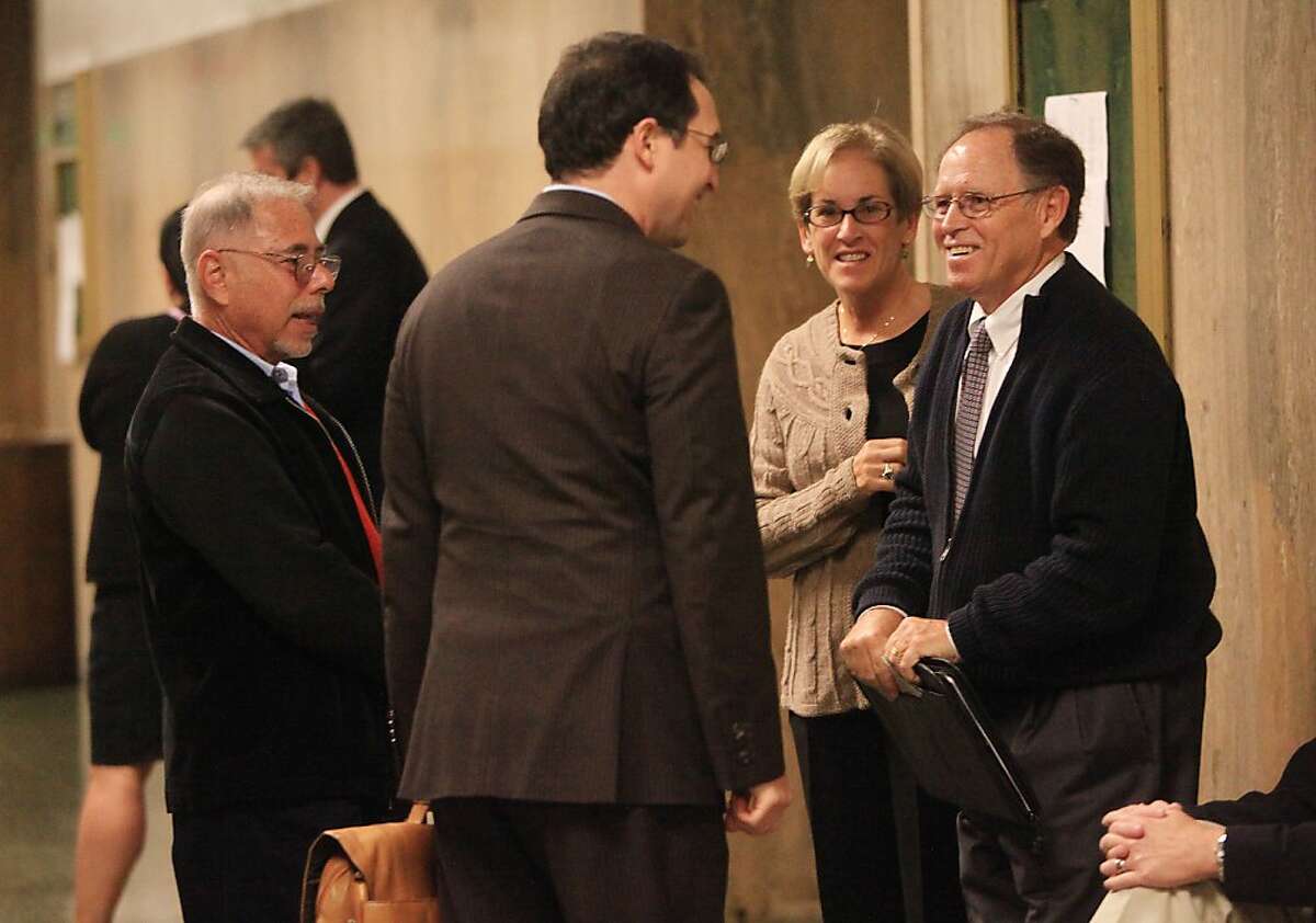 Former associate vice chancellor of City College of San Francisco Stephen Herman (left) and former City College of San Francisco Chancellor Philip Day (right) talk with attorney Daniel Roth (center) outside of Department 22 before being sentenced at the Hall of Justice on Tuesday, November 1, 2011 in San Francisco, Calif.