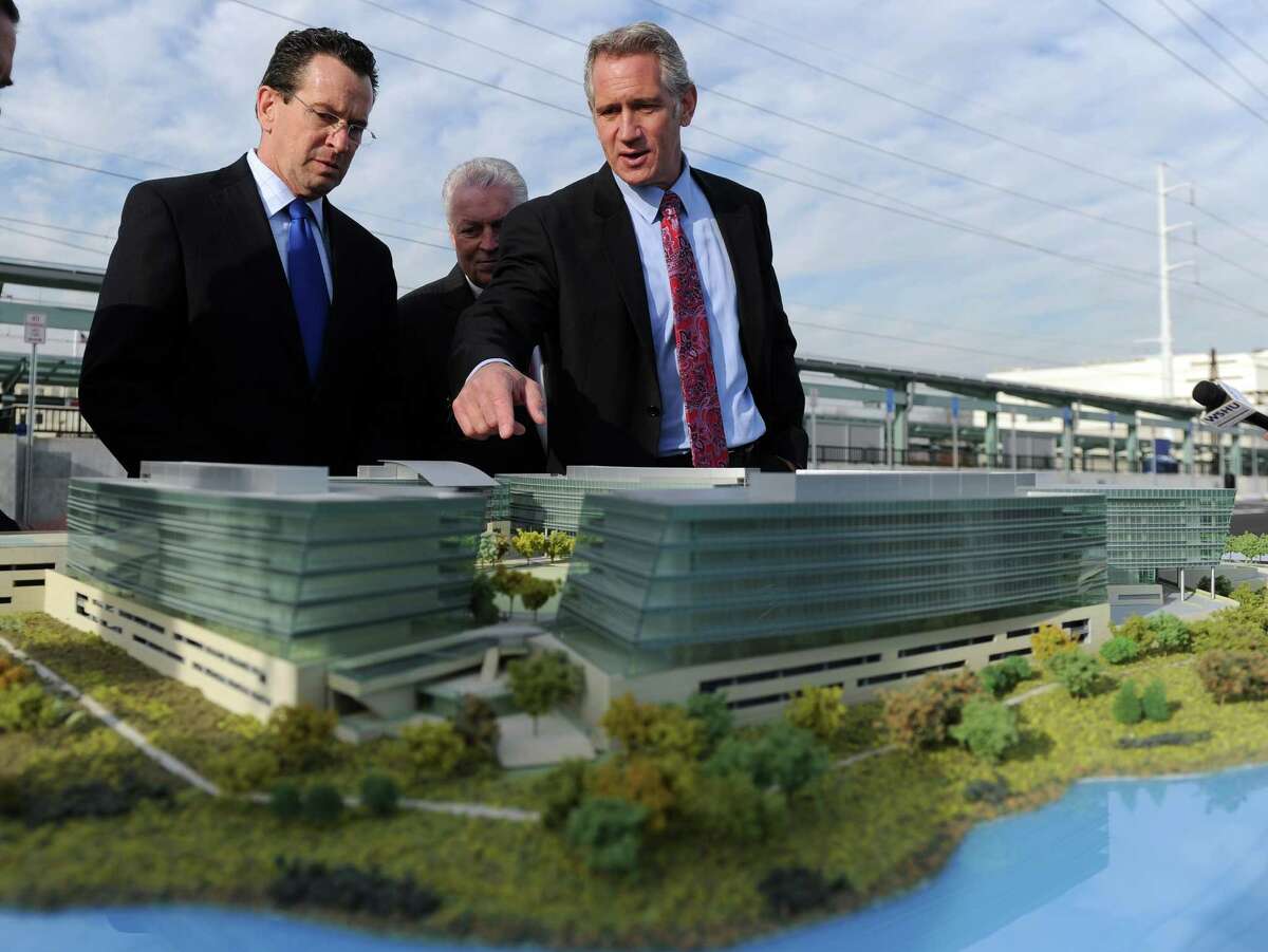 Plans for the Metro Station property have been altered since developer Kurt Wittek, right, showed off a scale model to Gov. Dannel P. Malloy in Decembe. But ongoing environmental oversight will be required.