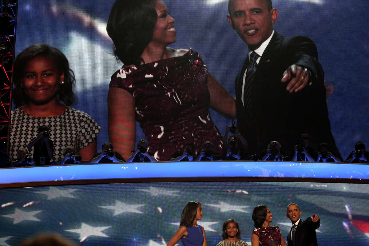 President Barack Obama, with his wife, Michelle Obama, and daughters, Malia, far left, and Sasha take the spotlight on stage at the conclusion of the Democratic National Convention at Time Warner Cable Arena in Charlotte, NC on Thursday, Sept. 6, 2012.
