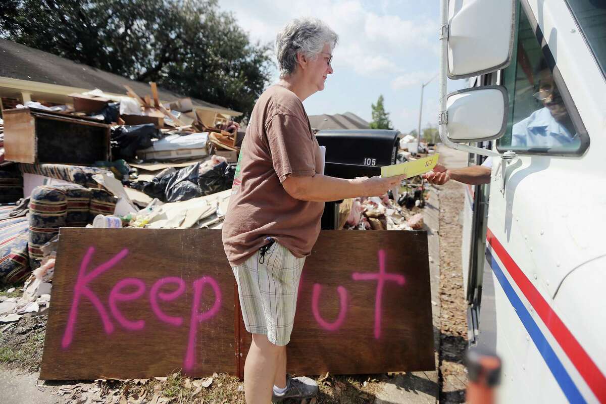 Marie Hauser receives her mail outside her flooded home on September 6, 2012 in LaPlace, Louisiana. Louisiana officials estimate that at least 13,000 homes were damaged by Hurricane Isaac. Louisiana officials estimate that at least 13,000 homes were damaged by Hurricane Isaac.