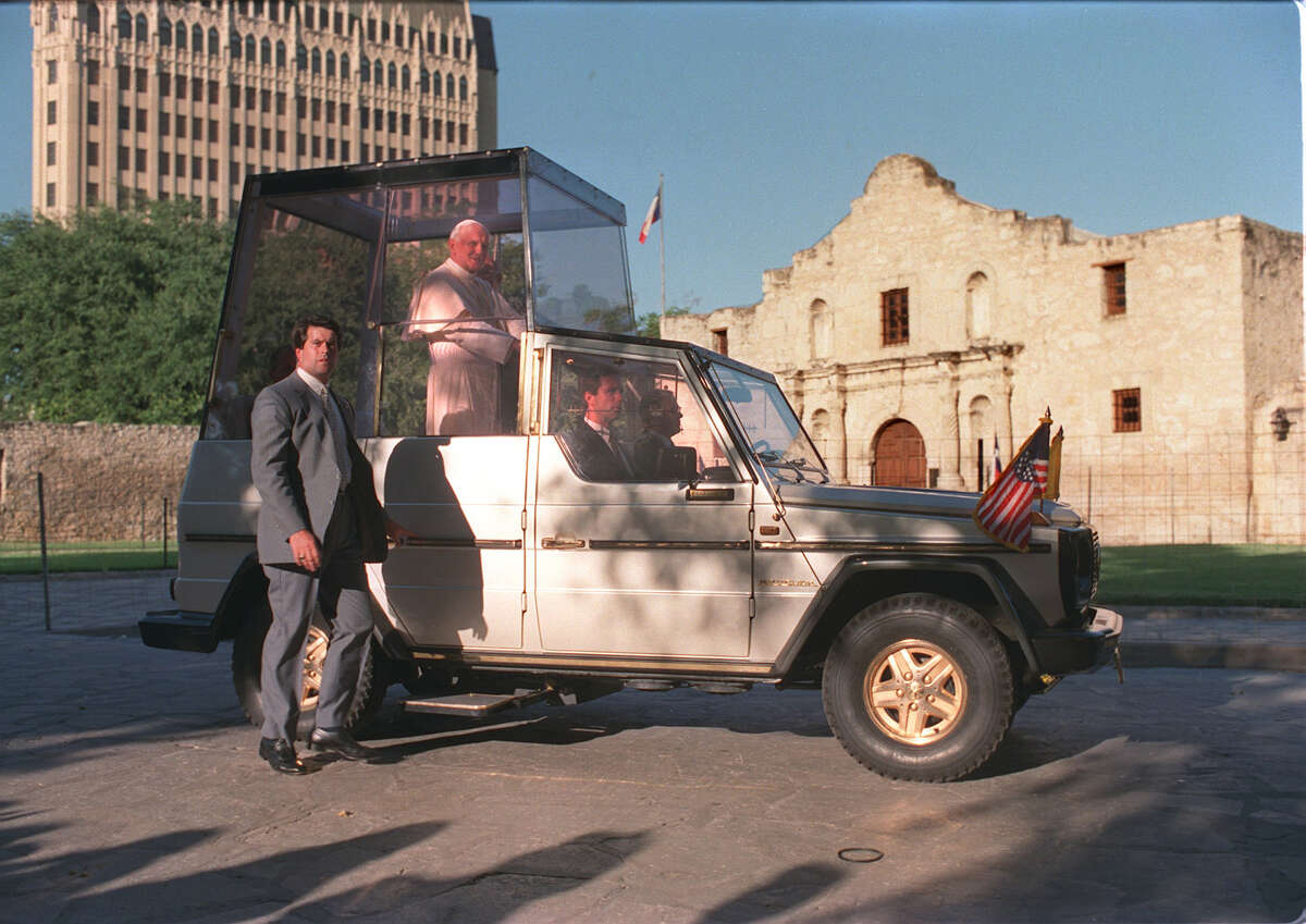 Pope John Paul II rides past the Alamo during his visit to San Antonio Sunday, Sept. 13, 1987.