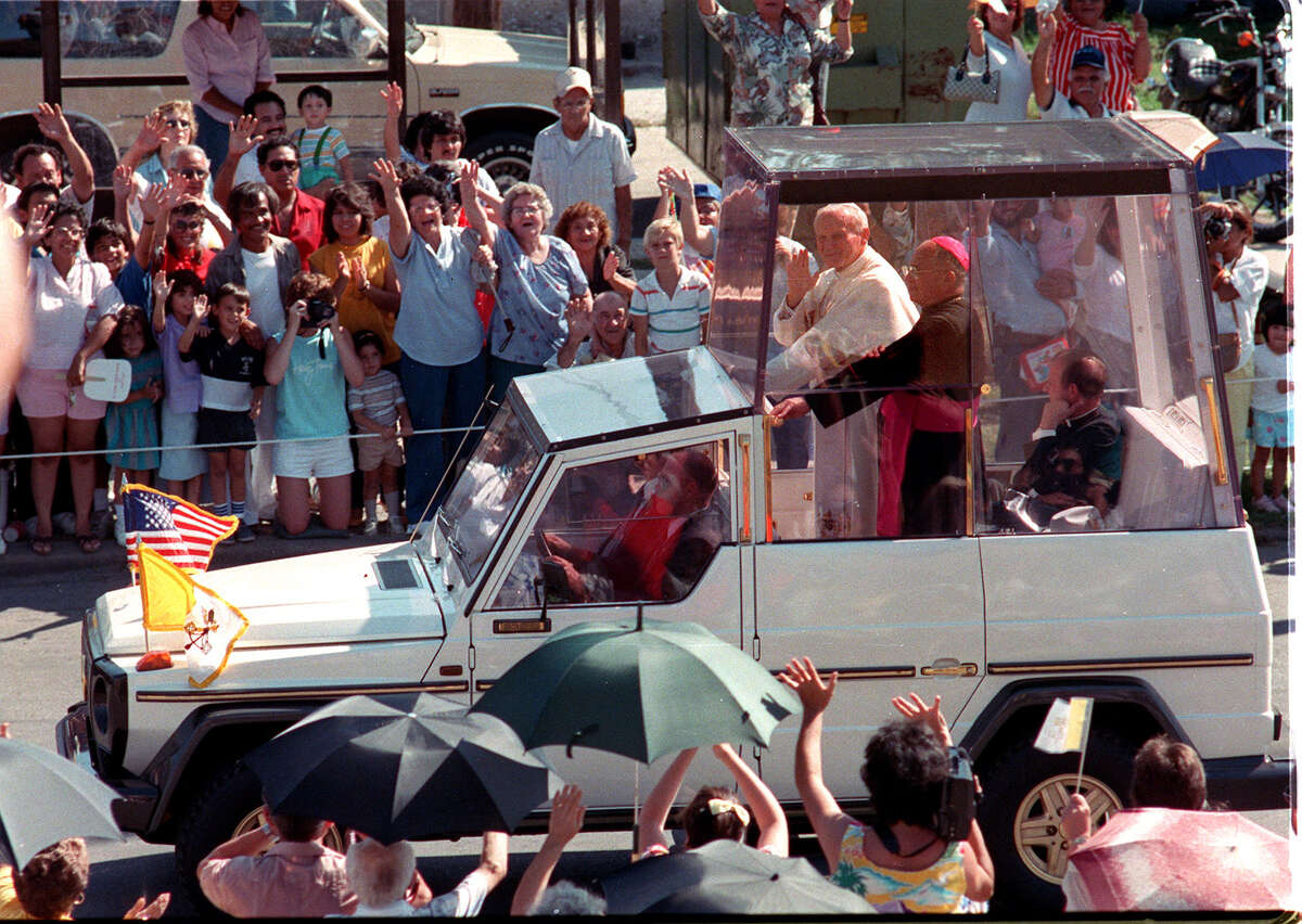 Pope John Paul II waves from the Pope Mobile to the crowd on W. Woodlawn and Zaramora on his way to downtown San Antonio during his visit on Sunday, Sept. 13, 1987.