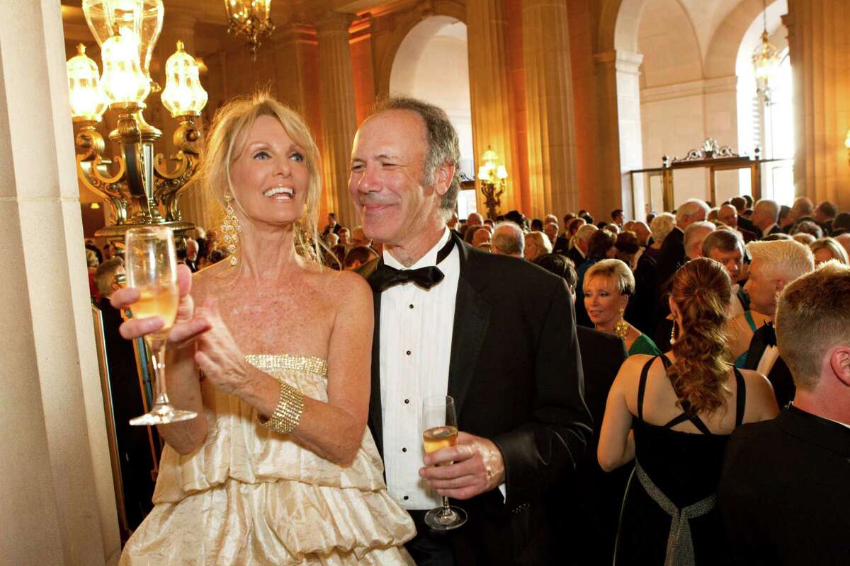 For the San Francisco Opera opening night in 2008, Belinda Berry wore a tiered dress using fabric from her bedskirt. She and her date, Tom Barrett, are seen appreciating musicians playing during the cocktail hour at the War Memorial Opera House in San Francisco.