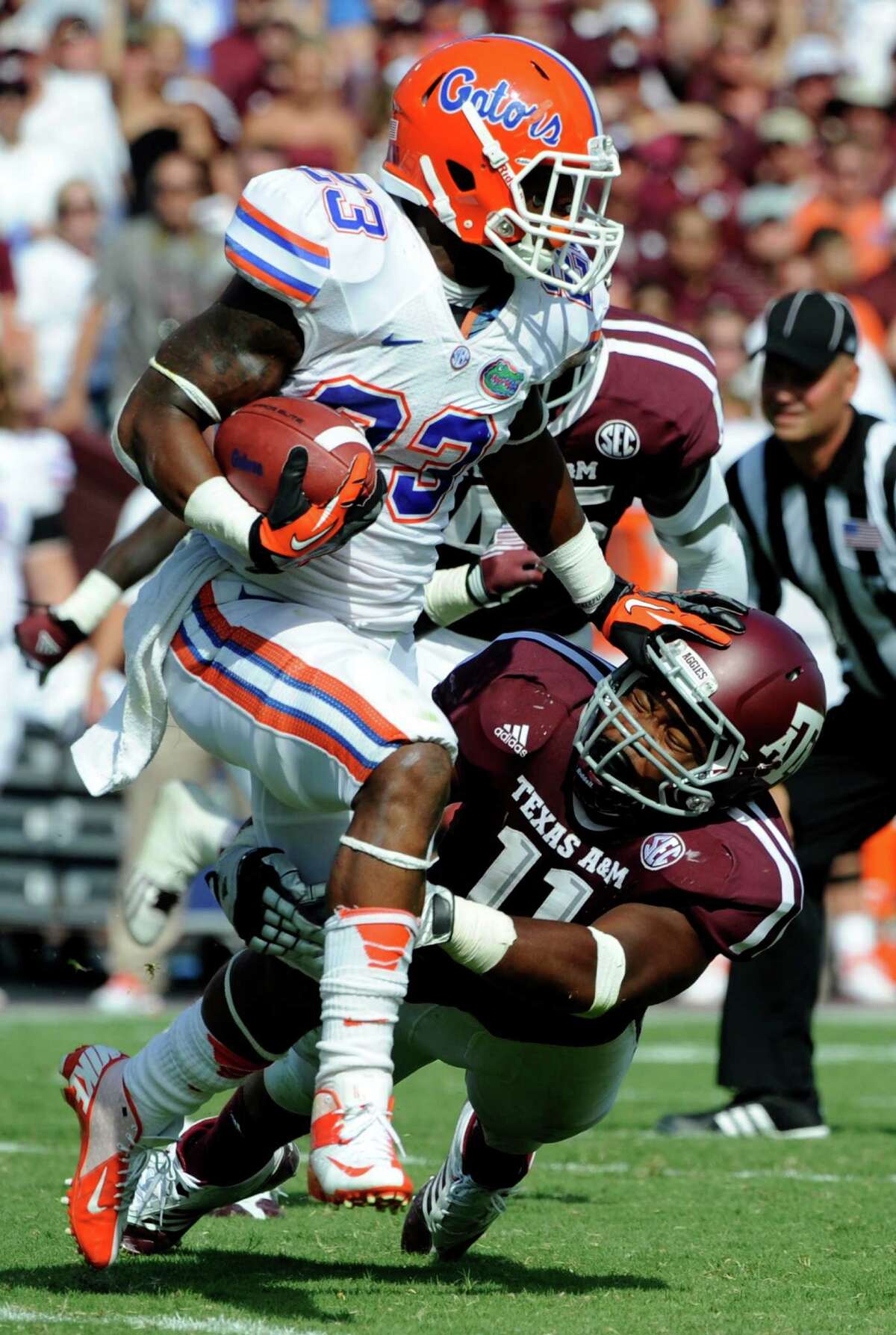 Florida running back Mike Gillislee (23) rushes for a gain as Texas A&M linebacker Jonathan Stewart (11) tries to tackle him during the third quarter of an NCAA college football game, Saturday, Sept. 8, 2012, in College Station, Texas. Florida beat Texas A&M 20-17. (AP Photo/Dave Einsel)