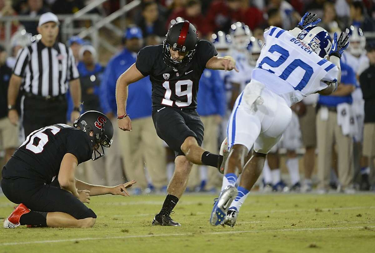 PALO ALTO, CA - SEPTEMBER 08: Jordan Williamson #19 of the Stanford Cardinals kicks a thirty two yard field goal past Lee Butler #20 of the Duke Blue Devils during the first quarter of an NCAA football game at Stanford Stadium on September 8, 2012 in Palo Alto, California. (Photo by Thearon W. Henderson/Getty Images)