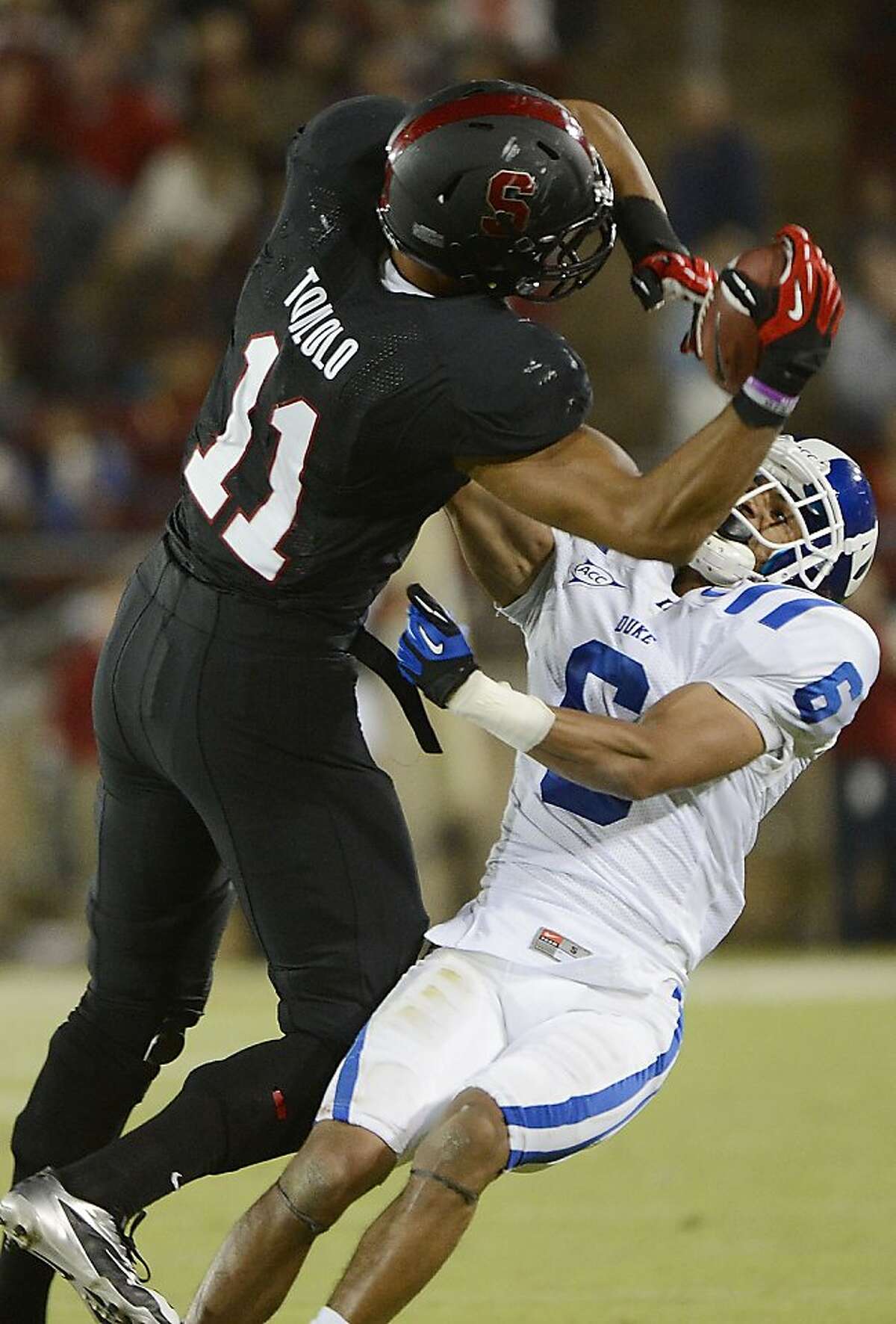 PALO ALTO, CA - SEPTEMBER 08: Levine Toilolo #11 of the Stanford Cardinals catches an eighteen yard pass over Ross Cockrell #6 of the Duke Blue Devils during the third quarter of an NCAA football game at Stanford Stadium on September 8, 2012 in Palo Alto, California. (Photo by Thearon W. Henderson/Getty Images)