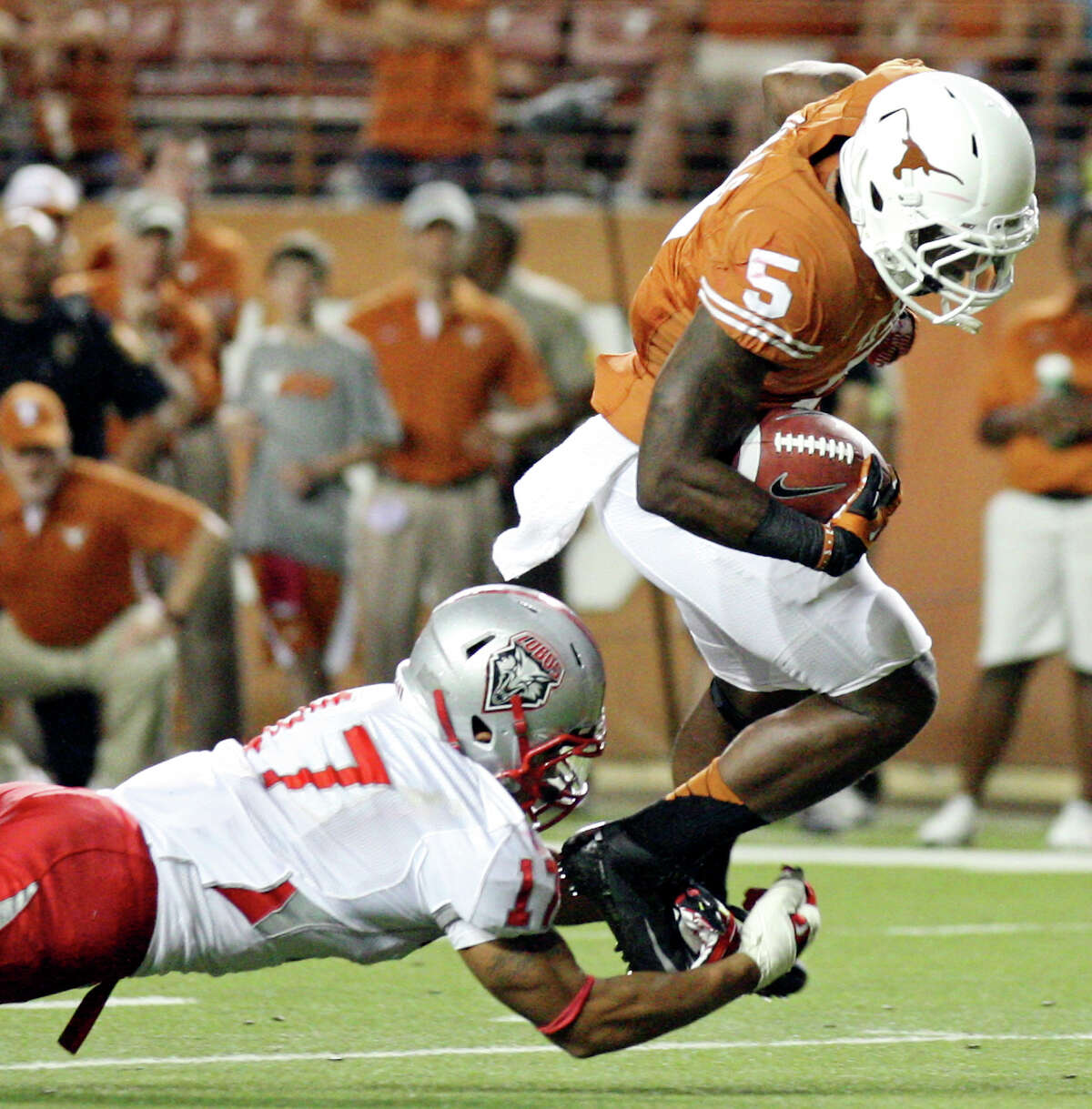 Texas Longhorns' Jeremy Hills tries to shake the tackle of New Mexico Lobos' Freddie Young during second half action Saturday Sept. 8, 2012 at Texas Memorial Stadium in Austin, Tx. The Longhorns won 45-0.