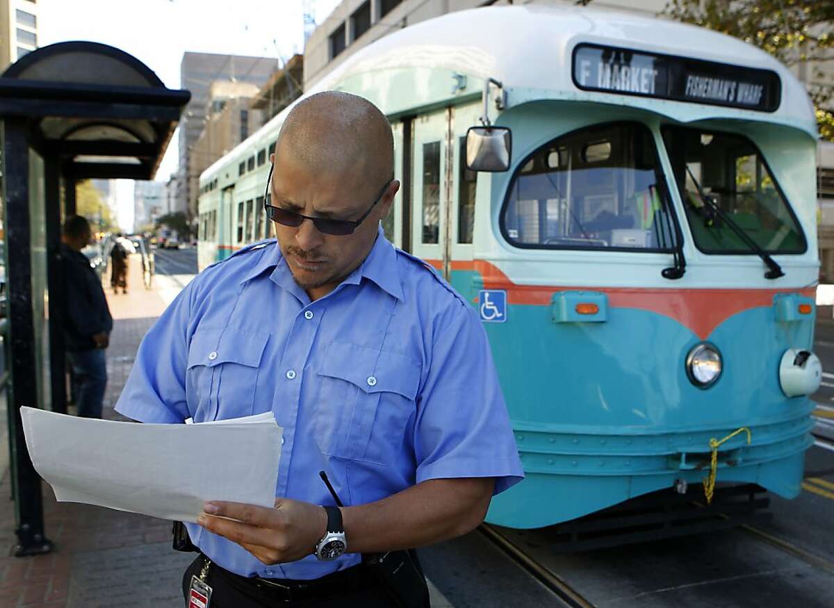 Muni street inspector Marcus Marcic logs the arrival time of an outbound F-Market streetcar at the corner of Van Ness Avenue and Market Street in San Francisco, Calif. on Friday, Sept. 7, 2012.