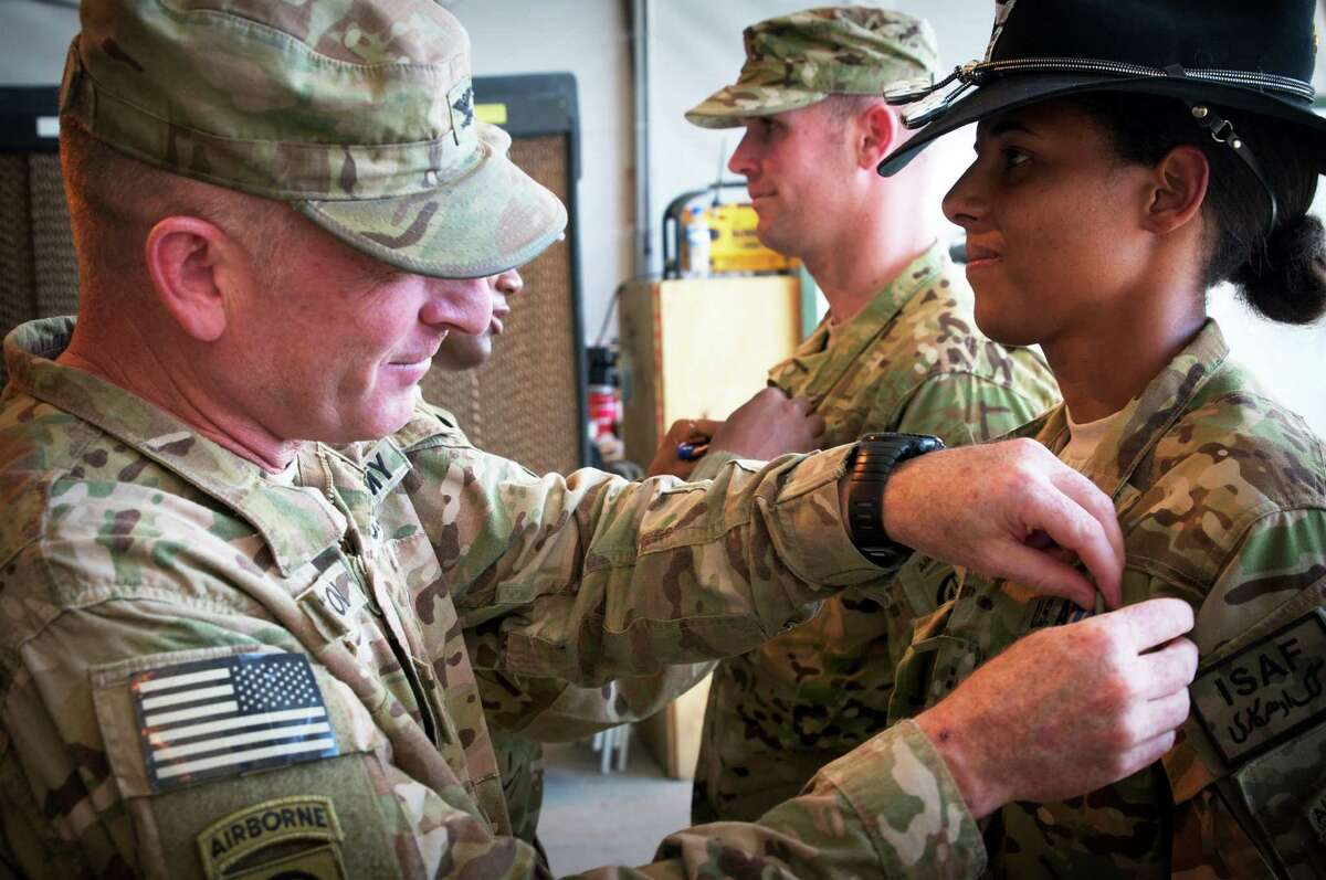 PARWAN PROVINCE, Afghanistan - U.S. Army Col. T.J. Jamison, 82nd Combat Aviation Brigade commander, of Broken Arrow, Okla., awards U.S. Army Chief Warrant Officer 2 Thalia Ramirez, of Nairobi, Kenya, with the Air Medal Aug. 30, 2012, on Bagram Airfield, Afghanistan. Ramirez, an OH-58D Kiowa Warrior pilot assigned to Troop F, 1-17 Air Cavalry Regiment, 82nd Combat Aviation Brigade, 82nd Airborne Division, was killed when her helicopter crashed in Logar Province, Afghanistan, Sept. 5, 2012. (U.S. Army photo by Sgt. 1st Class Eric Pahon)