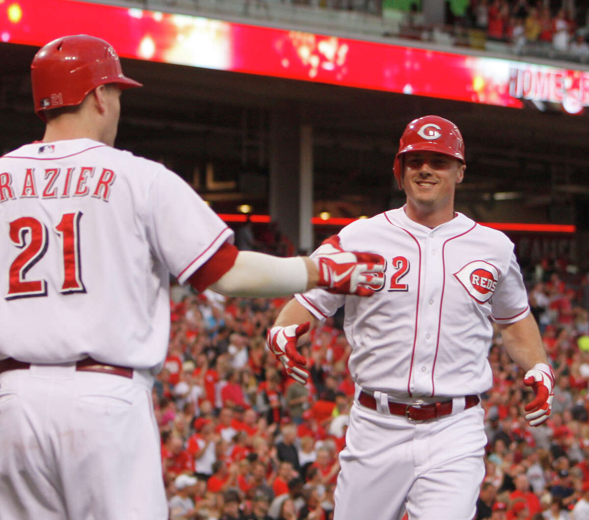 Cincinnati Reds' Jay Bruce (32) is congratulated by teammate Todd Frazier (21) after hitting a solo home run off Houston Astros starting pitcher Bud Norris in the second inning during a baseball game on Saturday, Sept. 8, 2012, in Cincinnati. (AP Photo/David Kohl)