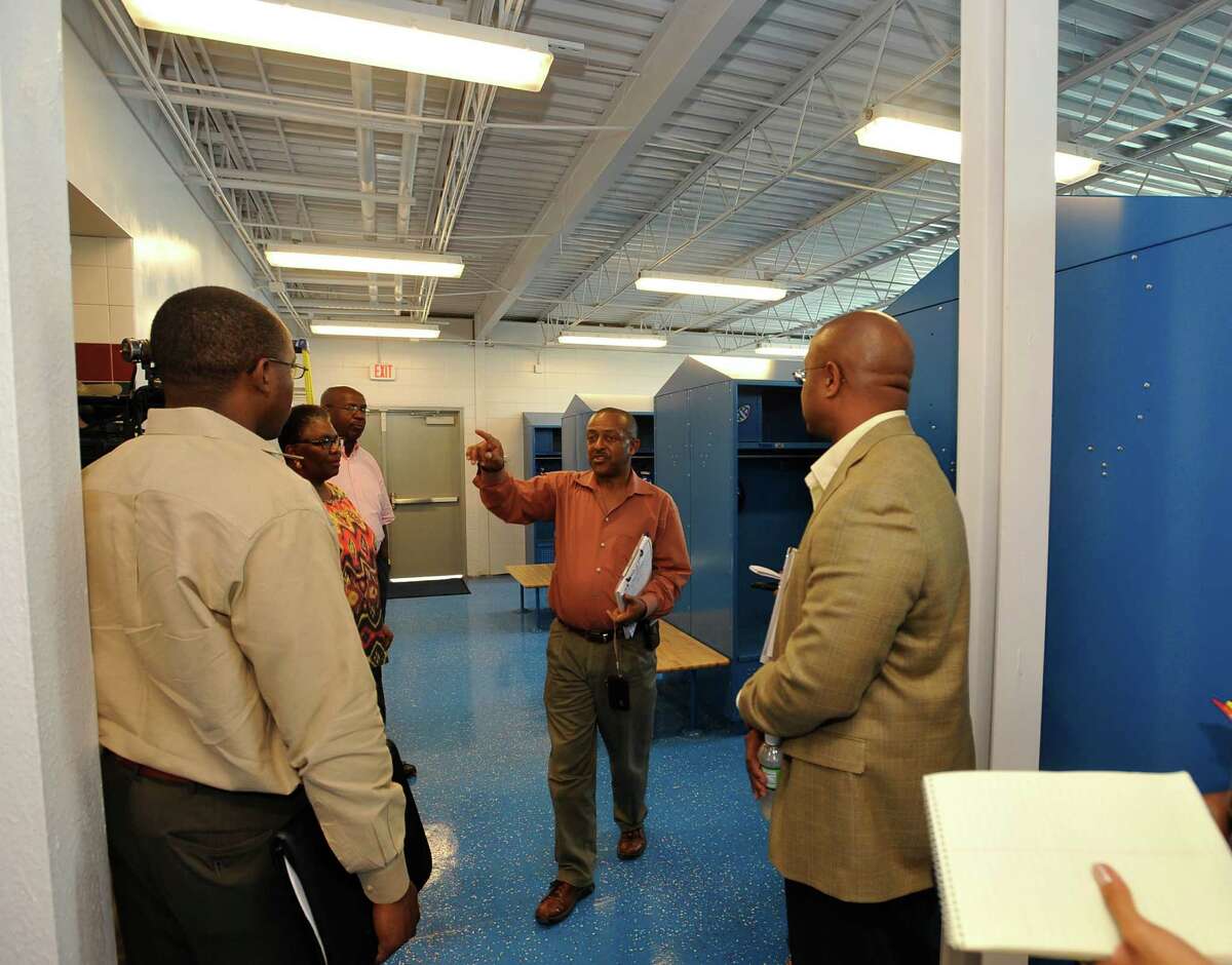 Bob Menefee, center, Project Manager with Parsons, leads BISD Superintendent -Elect Timothy Chargois, right, and others through the new team locker room. The BISD building and grounds committee used their meeting time Monday afternoon, August 13, 2012, to take a tour of some of the 2007 bond projects nearing completion including a walk through tour of the West Brook field house. Dave Ryan/The Enterprise
