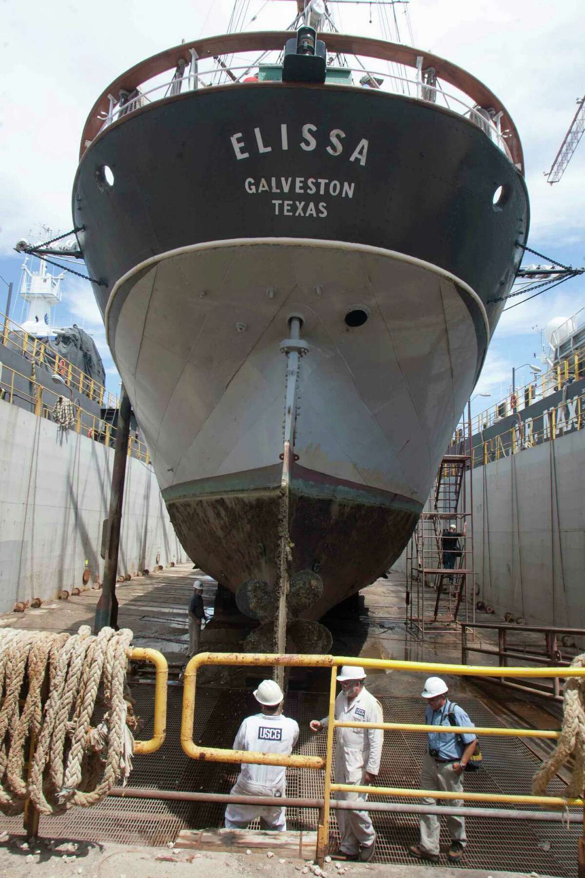 Work crews at a dry dock in Texas City take a look at the Elissa on Monday. The ship's iron hull is nearly eaten through in places because of unusually rapid corrosion caused when bacteria was churned up by Hurricane Ike.