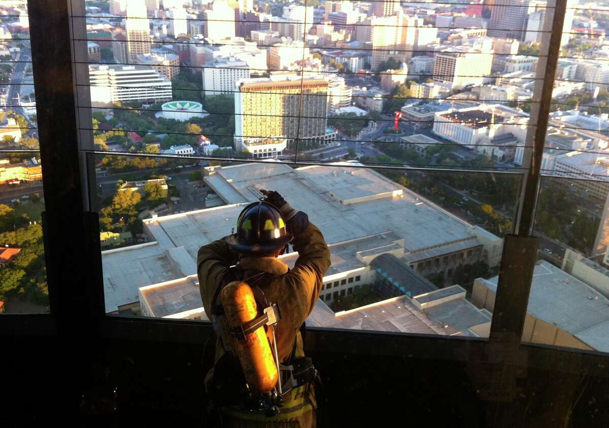 Firefighter Nick Lawrence ponders the moment after climbing the Tower of the Americas in San Antonio on Tuesday, Sept. 11, 2012, to commemorate New Yourk City firefighters that perished on Sept. 11, 2001.
