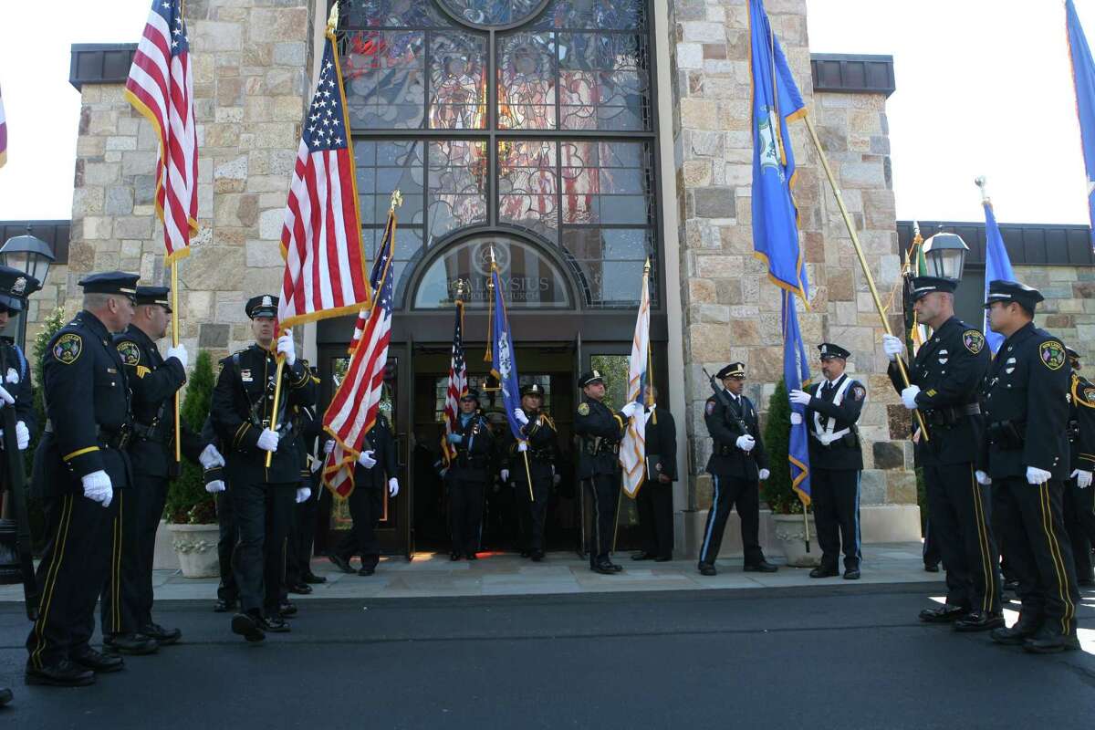 Area law enforcement, fire and emergency medical service personnel attend the annual Diocesan Blue Mass at Saint Aloysius Roman Catholic Church on Sunday, Sept. 9, in New Canaan, Conn. The mass commemorates the eleventh anniversary of 9-11.