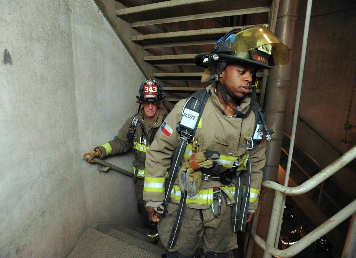 Firefighters climb the stairs within the Tower of the Americas during the 9/11 Patriot Day Tower Ascent to remember the firefighters that perished on Sept. 11, 2001, and to raise funds for the National Fallen Firefighters Foundation on Tuesday, Sept. 11, 2012. Participants climbed the Tower of the Americas -- some twice, to equal the height of the 110 floors of the World Trade Center. The event was sponsored by the Family Education Alliance of South Texas.