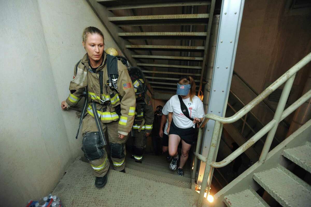 Firefighter Dawn Solinski and others climb the stairs within the Tower of the Americas during the 9/11 Patriot Day Tower Ascent to remember the firefighters that perished on Sept. 11, 2001, on Tuesday, Sept. 11, 2012.