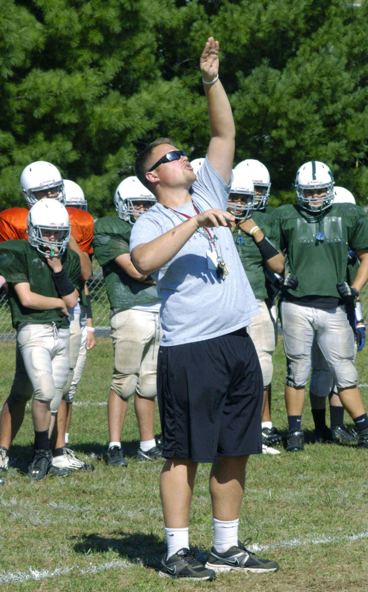 Assistant coach Travis Swim and his fellow coaches hope to guide New Milford High School football to the heights this fall. September 2012