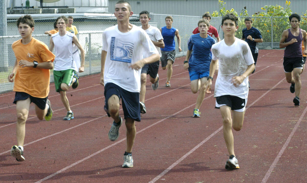 The Green Wave's, from the left, Luke Simmonds, Phil Young and Eric Vasquez show the way for teammates ina pre-season drill for New Milford High School boys' cross country, September 2012
