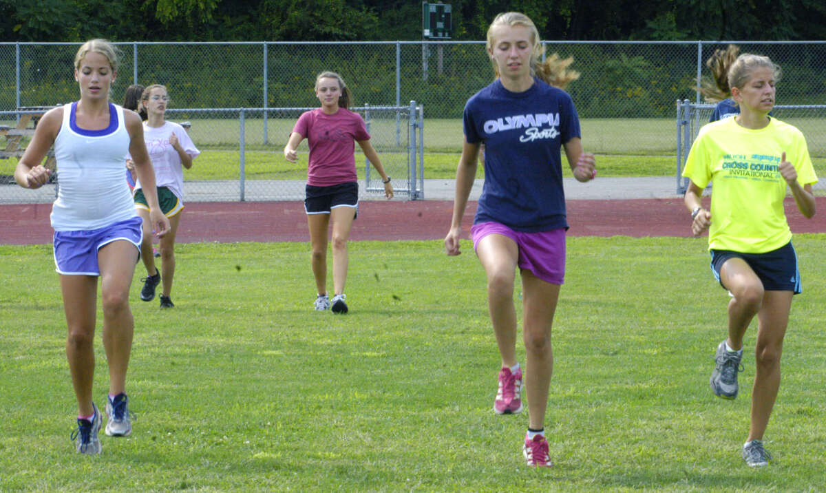 Engaged in drills during pre-season are, from left to right, Nicole McCarthy, Marissa Stumpf and Sofia Amaral of New Milford High School girls' cross country. September 2012