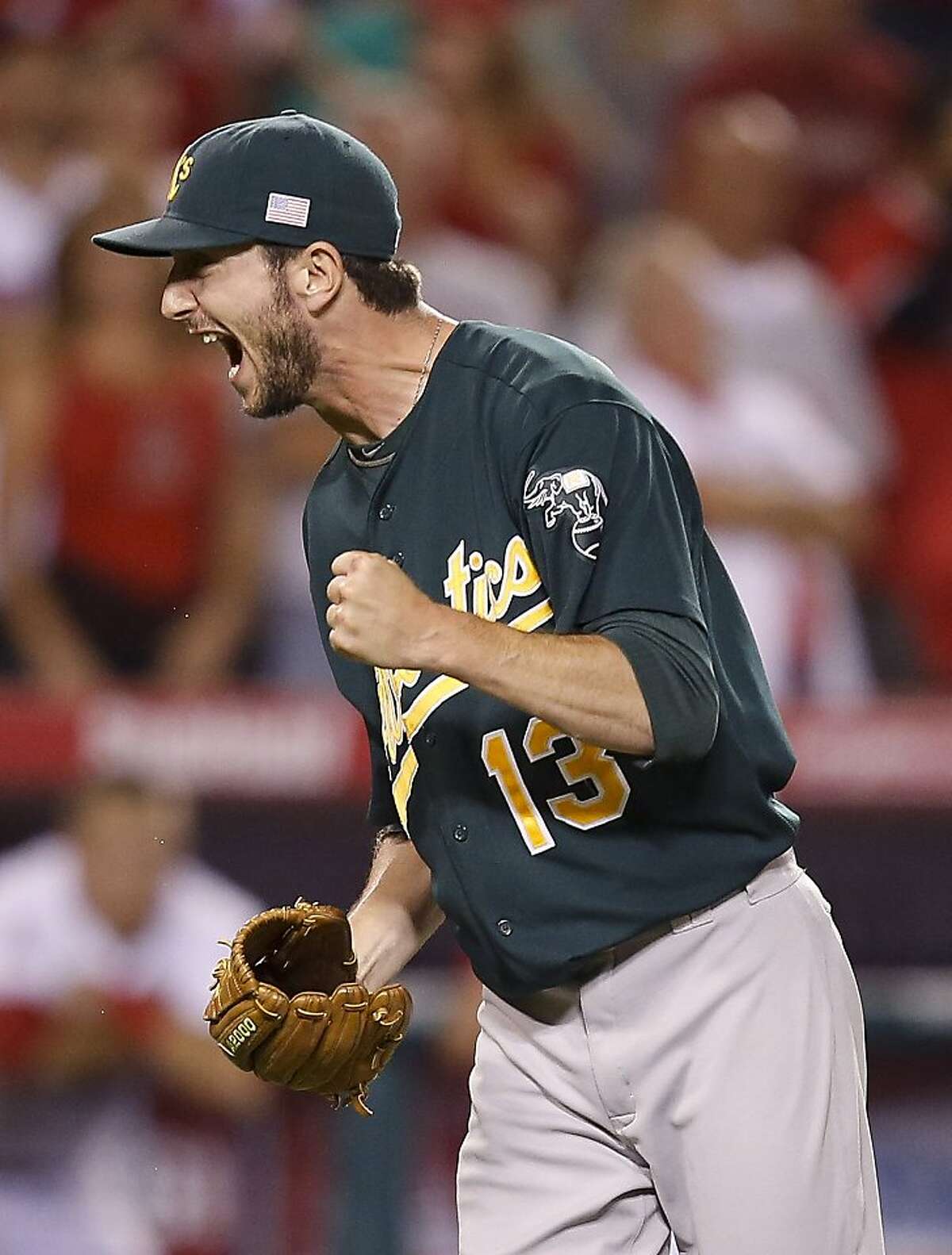 Oakland Athletics relief pitcher Jerry Blevins celebrates his team's 6-5 win against the Los Angeles Angels after a baseball game in Anaheim, Calif., Tuesday, Sept. 11, 2012. (AP Photo/Jae C. Hong)