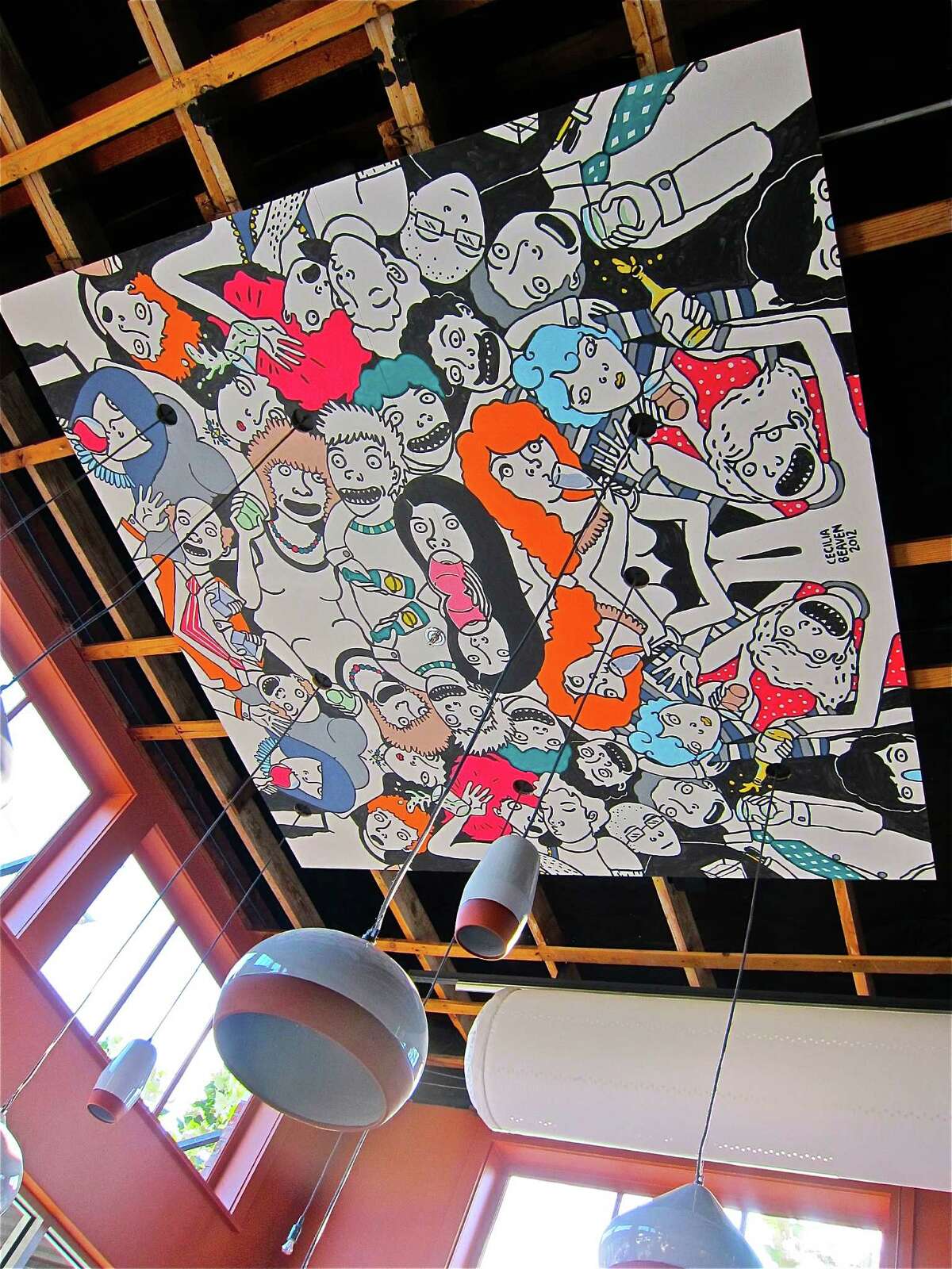 The cartoony murals of Cecilia Beaven decorate the ceiling of Cuchara.