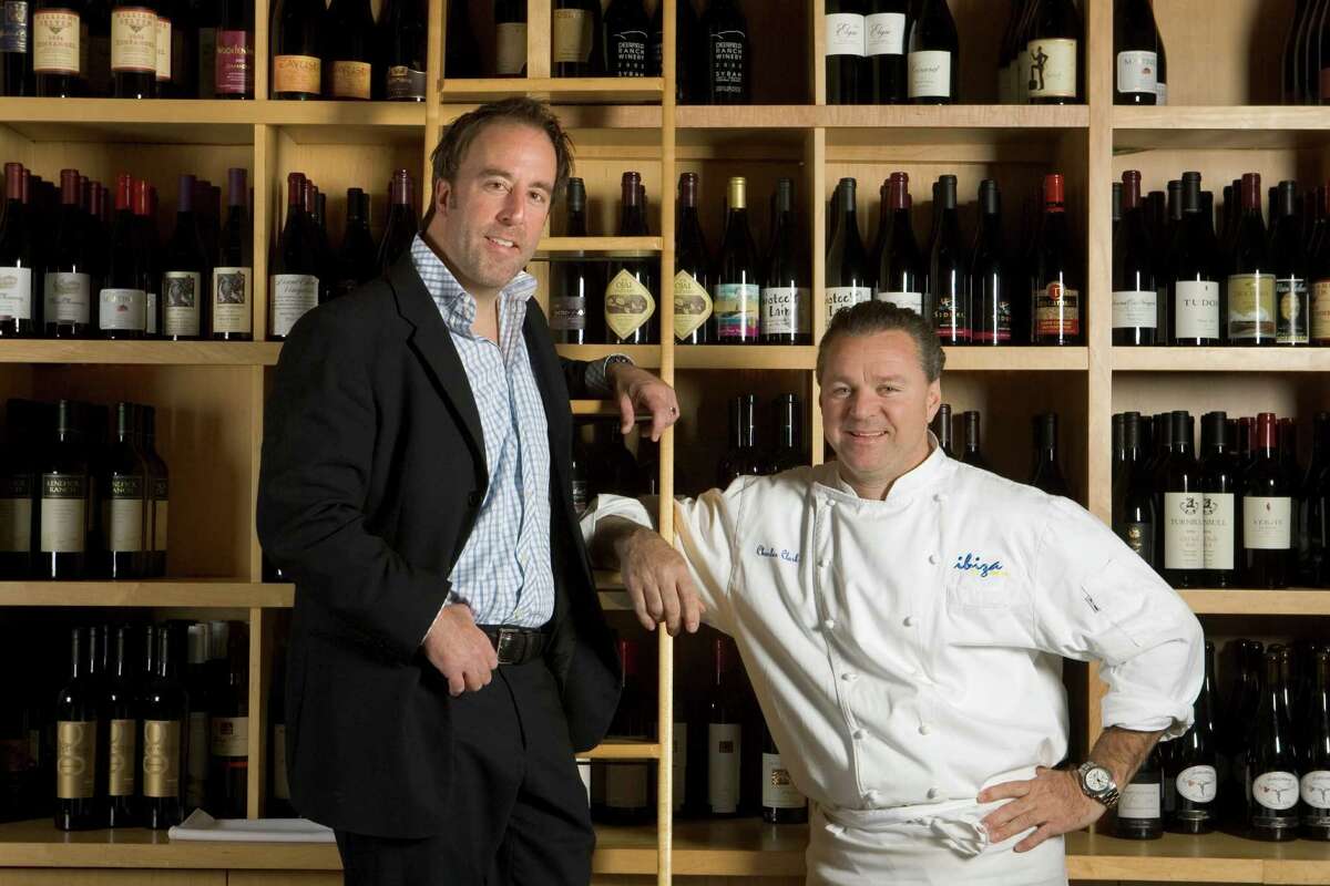 Ibiza Food and Wine Bar owners Grant Cooper, left, and Charles Clark pose for a portrait in front of the restaurant's wine wall Friday, March 7, 2008, Houston. ( Brett Coomer / Chronicle )