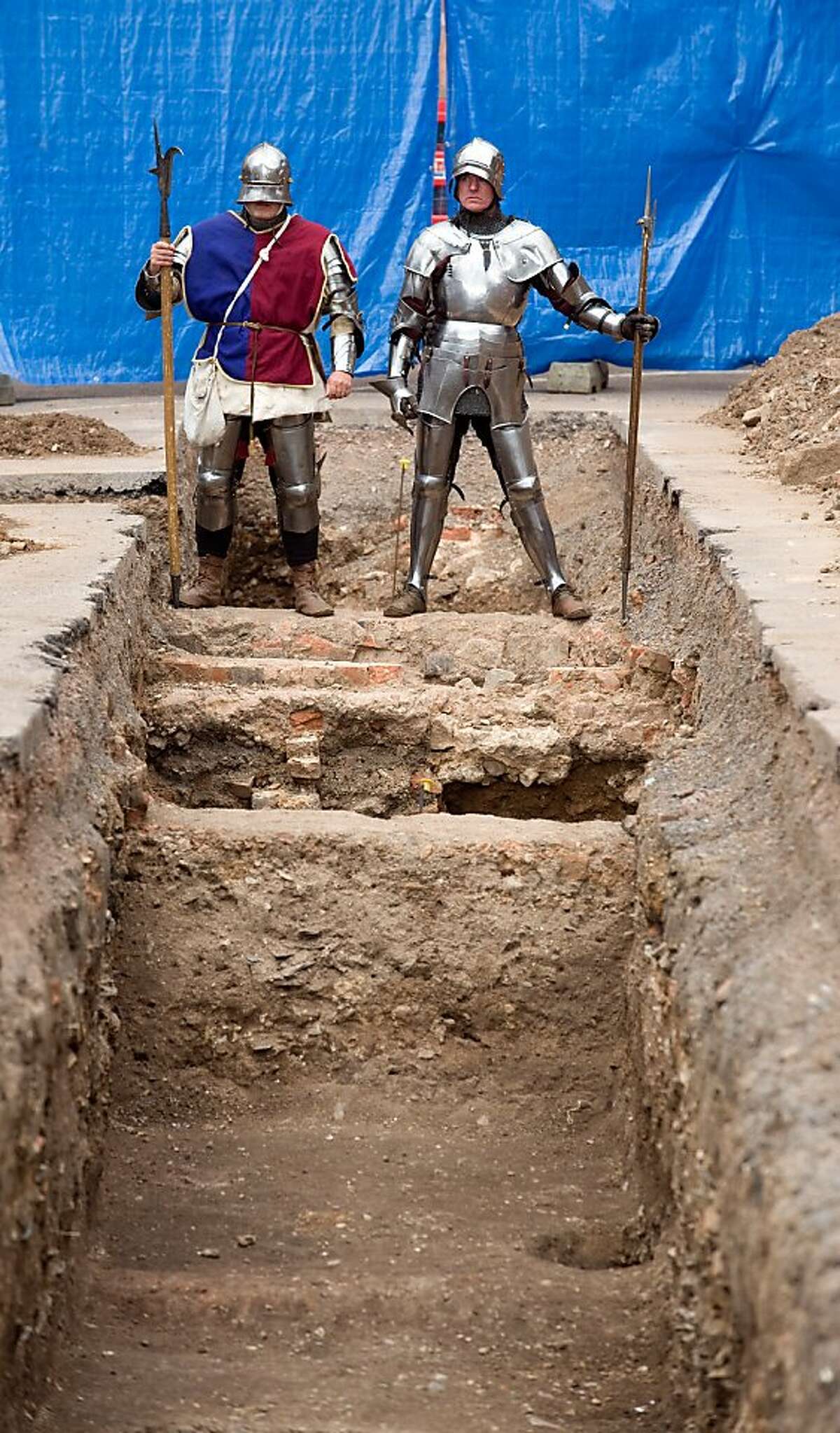 Men dressed as medieval knights pose for pictures in Leicester in central England, on September 12, 2012, at a site where a skeleton that researchers believe could be British medieval king Richard III was found. Researchers from the University of Leicester said they had found a male skeleton with similarities to historical descriptions of Richard, who ruled England between 1483 and his death in battle in 1485. The remains, which are well preserved, are undergoing DNA analysis. "What we have uncovered is truly remarkable," said Richard Taylor, the university's director of corporate affairs. AFP PHOTO / Gavin FoggGavin Fogg/AFP/GettyImages
