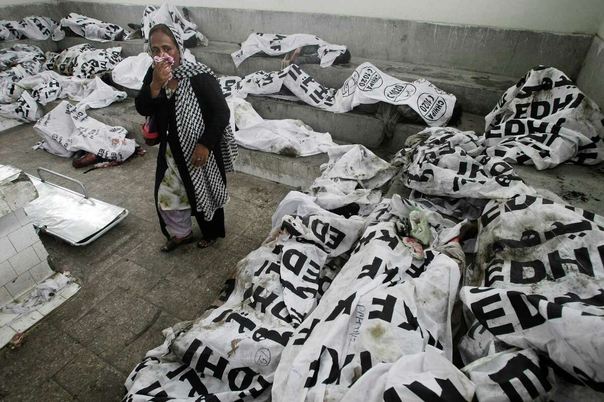 A woman looks for a missing family member at a morgue in Karachi, Pakistan, on Wednesday after devastating factory fires broke out in two major cities, killing hundreds of people.
