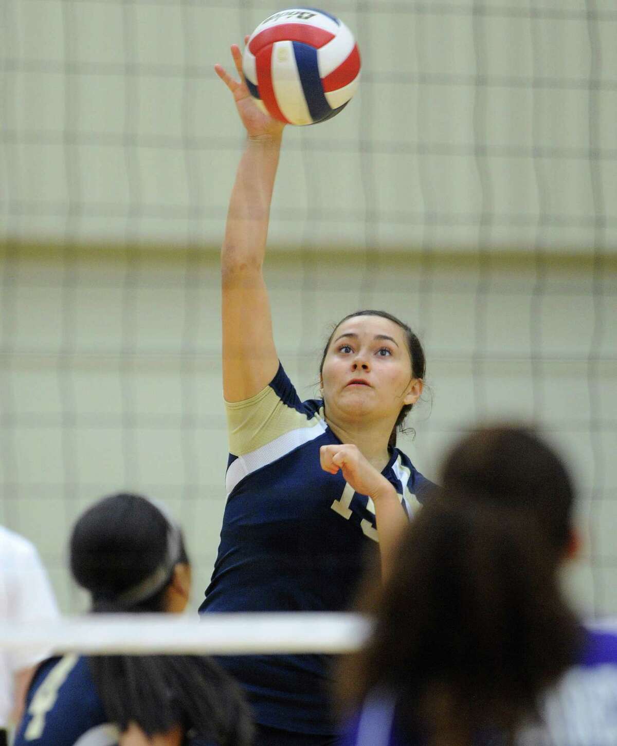 O'Connor's Brianna Sotello hits the ball during girls volleyball action against Warren at the Taylor Fieldhouse on Wednesday, Sept. 12, 2012.