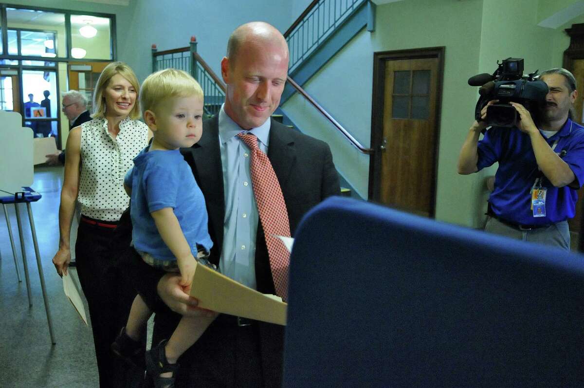 Lee Kindlon, Democratic candidate for Albany County District Attorney holds his son Cole, 1, while preparing to cast his ballot at the Bethlehem Middle School while voting in the primary on Thursday Sept. 13, 2012 in Delmar, NY. His wife Liz stands behind him. (Philip Kamrass / Times Union)