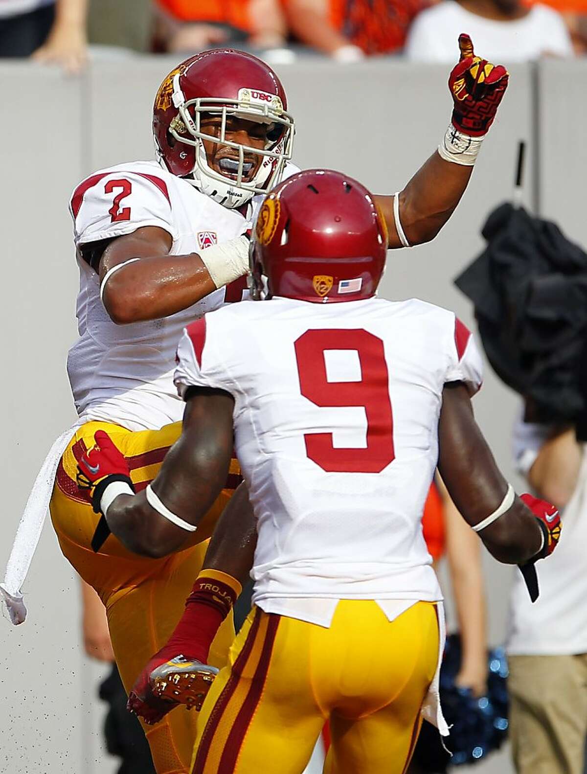 EAST RUTHERFORD, NJ - SEPTEMBER 8: Robert Woods #2 of the USC Trojans celebrates his touchdown catch with teammate Marqise Lee #9 against the Syracuse Orange in the first half during a game at MetLife Stadium on September 8, 2012 in East Rutherford, New Jersey. (Photo by Rich Schultz /Getty Images)