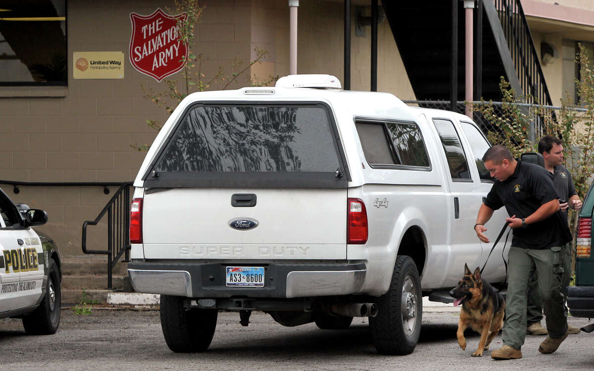 A member of the San Antonio Police Department's bomb squad makes a sweep with a dog at the Salvation Army after a bomb threat was made at its location at 226 Nolan Street Friday September 14, 2012. The call came in at about 8:00 a.m. and the all clear was given by police at 9:40 a.m. .