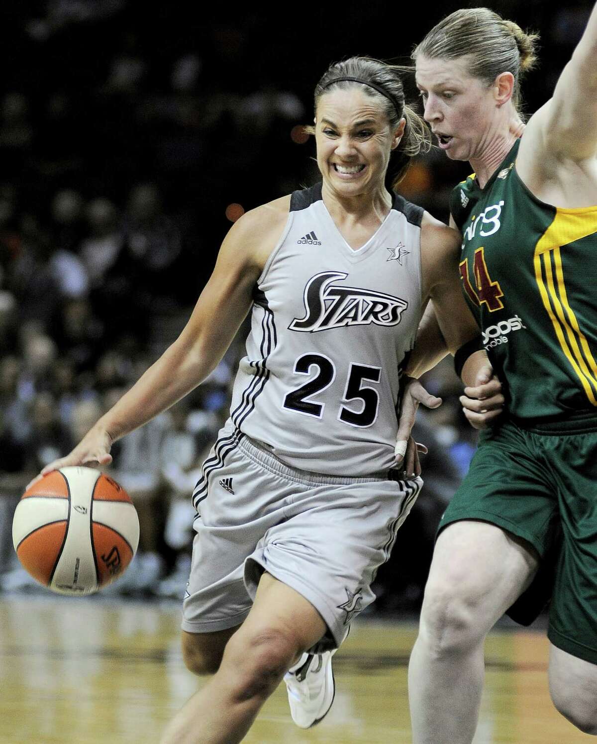 San Antonio Silver Stars' Becky Hammon (25) drives around Seattle Storm's Katie Smith during the first half of a WNBA basketball game, Friday Sept. 14, 2012, in San Antonio.