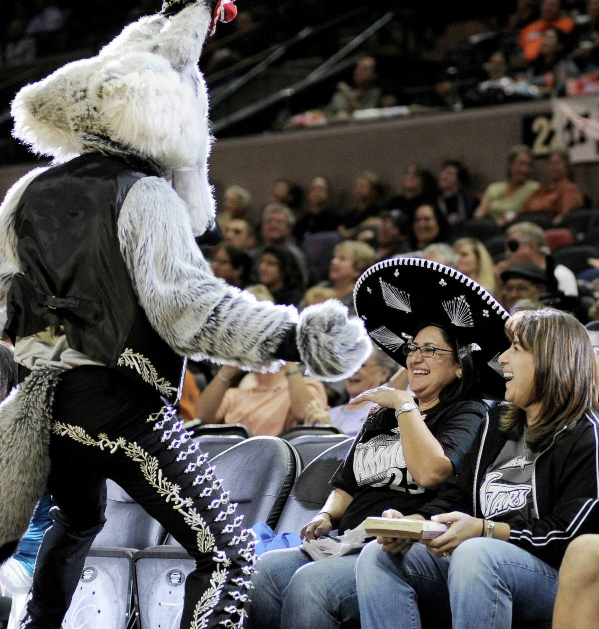 San Antonio Silver Stars mascot The Fox plays with fans during the first half of a WNBA basketball game against the Seattle Storm, Friday Sept. 14, 2012, in San Antonio. San Antonio won 90-66.