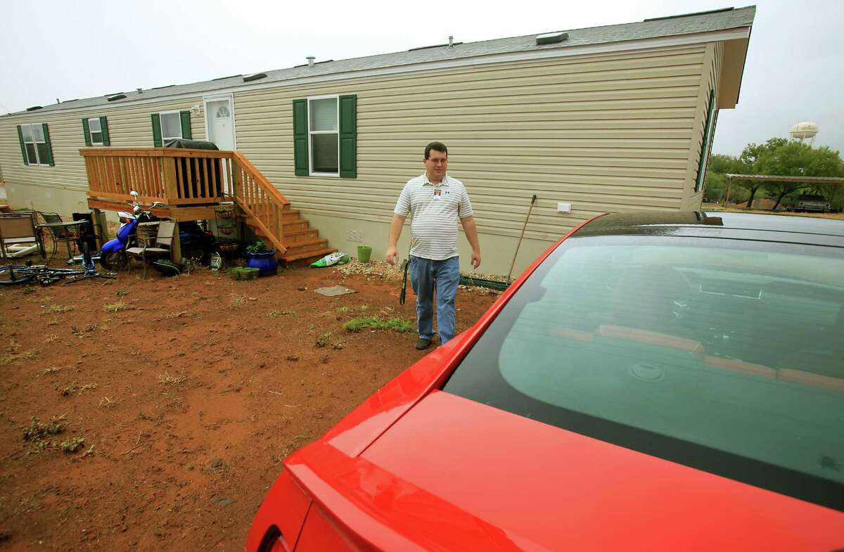 Kevin Billings, technology director of the Cotulla Independent School District, lives in a mobile home parked on district property. District officials have had to find creative ways to help employees afford area housing.