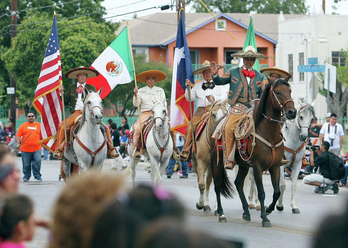 Caballeros or cowboys carrying the U.S., Texas and Mexico flags stroll down the street at the 31st Annual 16 de Septiembre Parade hosted by Avenida Guadalupe Association on Saturday, Sept. 15, 2012. Parade goers gathered to see nearly 40 floats joined high school marching bands and drill teams along the route to celebrate Mexico's independence from Spain.